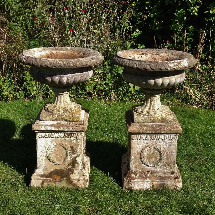 Pair of Weathered Urns and Pedestals 