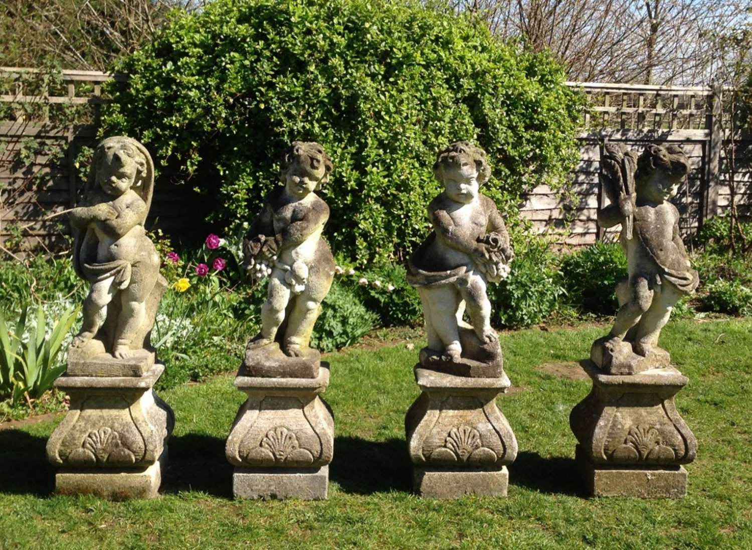 Set of Four Carved Limestone Statues