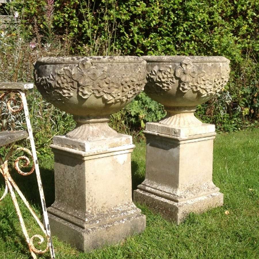 Pair of Weathered Garden Urns on Pedestals