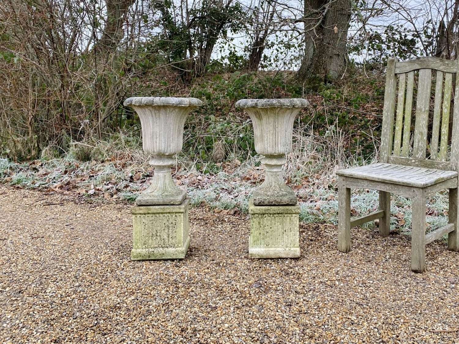 Pair of Small Fluted Urns with Plinths