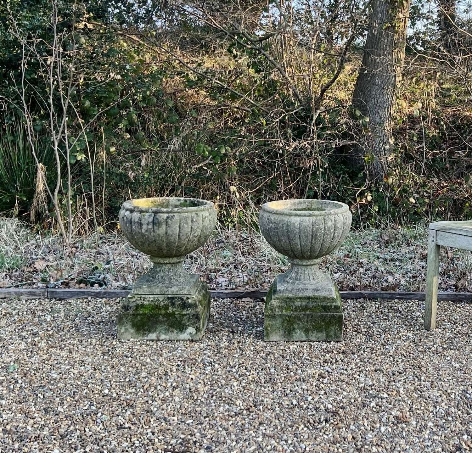 Pair of Patinated Melon Urns on Plinths