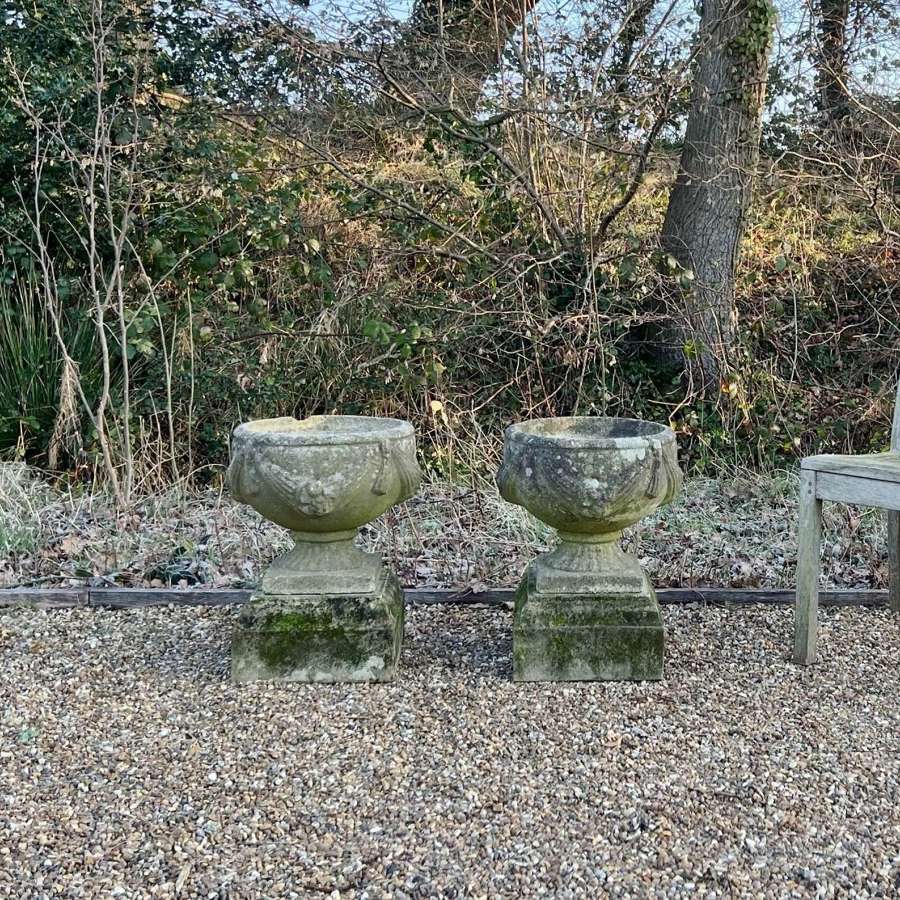 Pair of Patinated Goblet Urns on Plinths