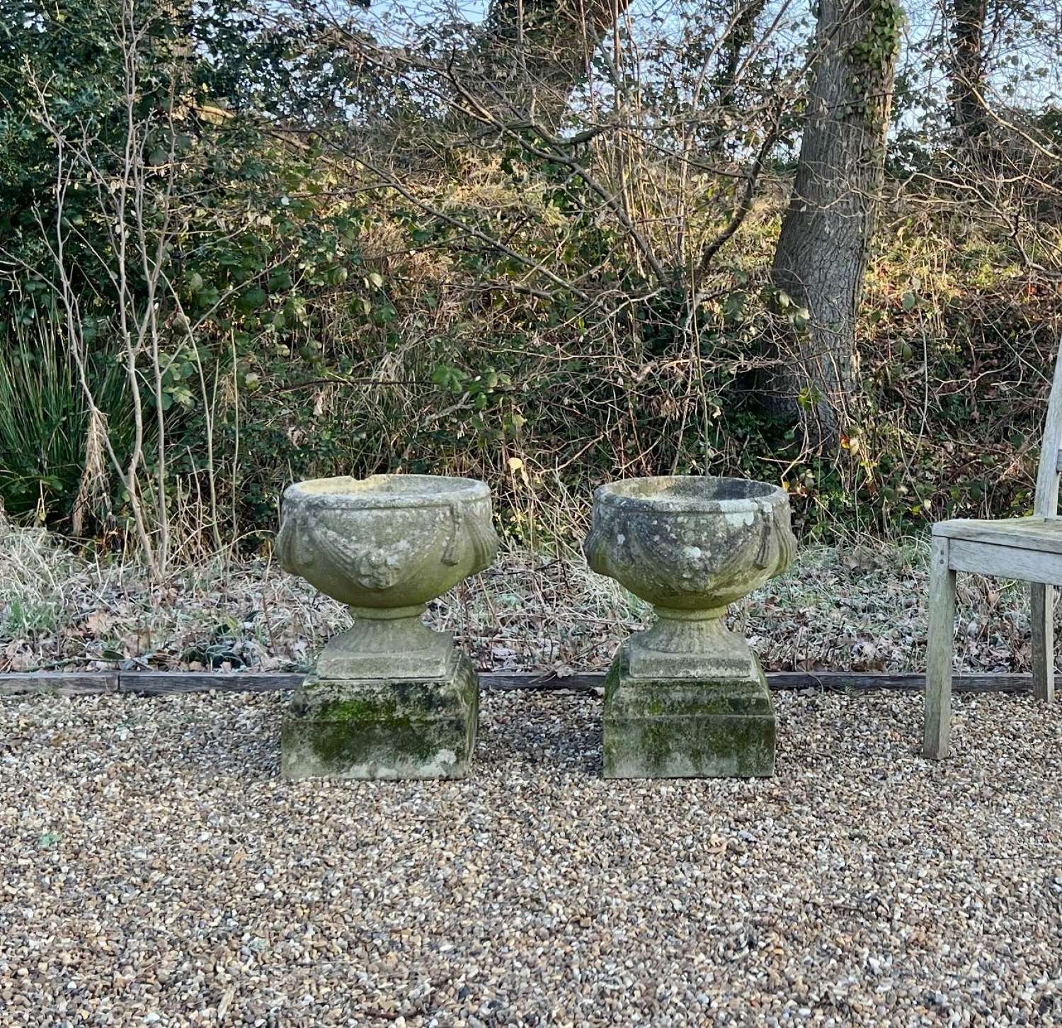 Pair of Patinated Goblet Urns on Plinths