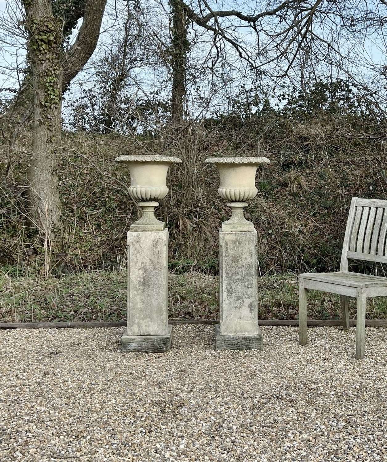 Pair of Small Campania Urns on Tall Pedestals