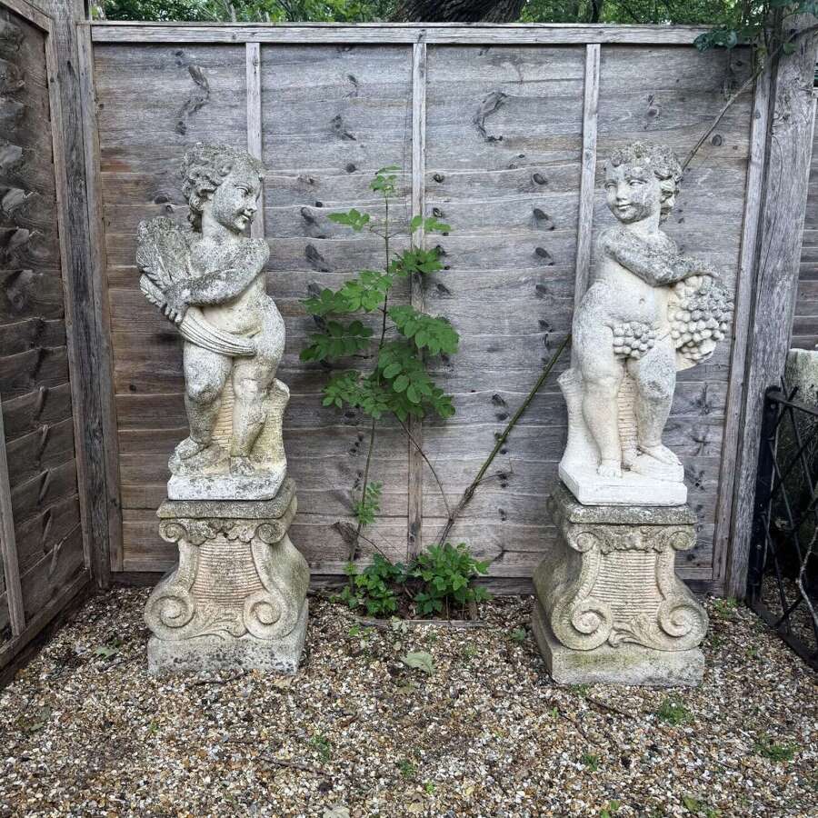 Pair of Cherubs on Scroll Pedestals